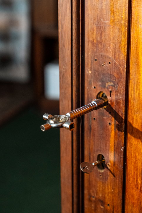 A door handle and key in mahogany